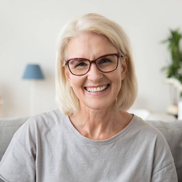 Happy woman wearing glasses and smiling with beautiful teeth