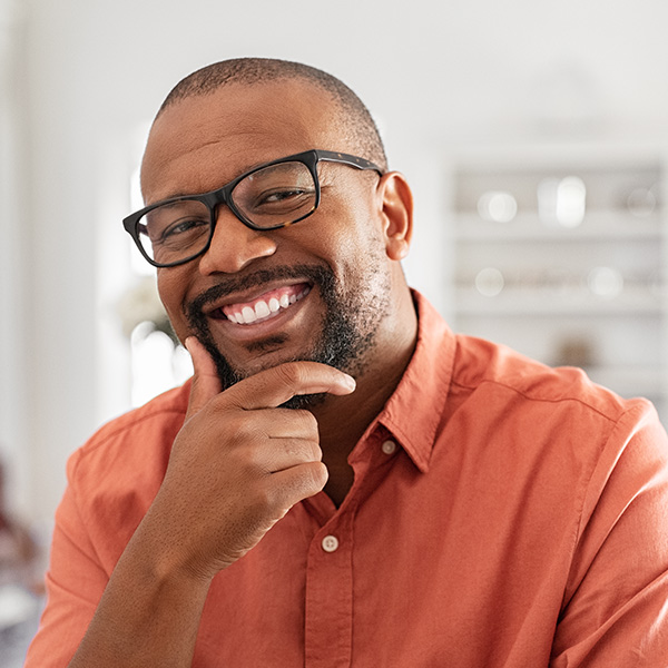 Happy man wearing glasses and smiling with beautiful teeth