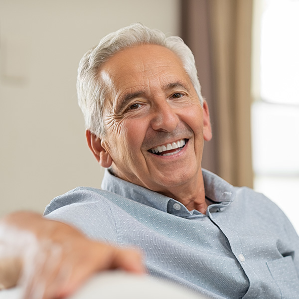 Happy elderly man smiling with beautiful teeth