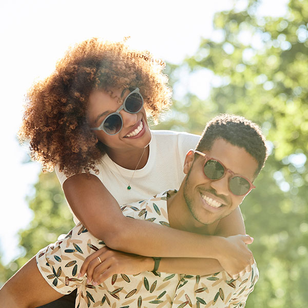 Happy couple smiling wearing sunglasses