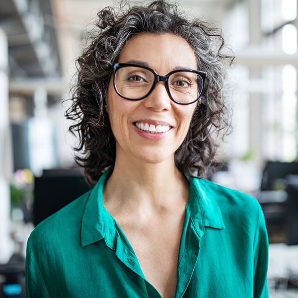 Happy woman wearing glasses and smiling with beautiful teeth