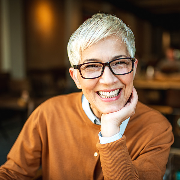 Happy woman smiling wearing glasses and showing her beautiful teeth