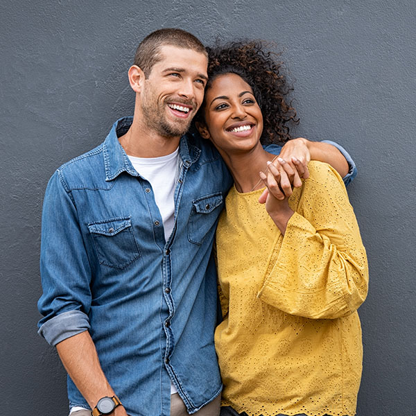 Happy couple smiling with beautiful teeth