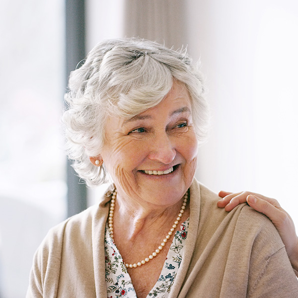 Happy elderly woman smiling with beautiful teeth