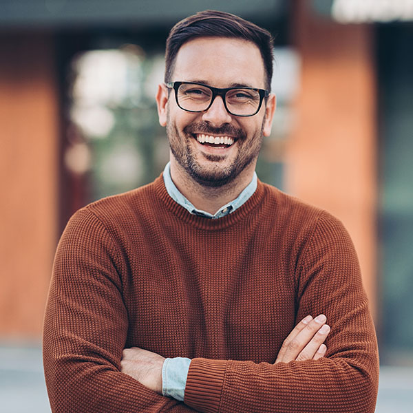 Happy man wearing glasses and smiling with beautiful teeth